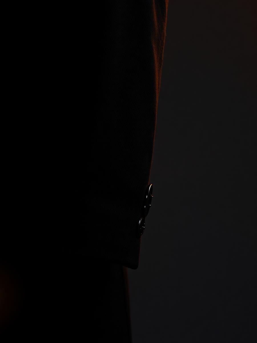 Close-up of the overcoat sleeve and horn button detail